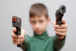 Young boy with plastic pistol